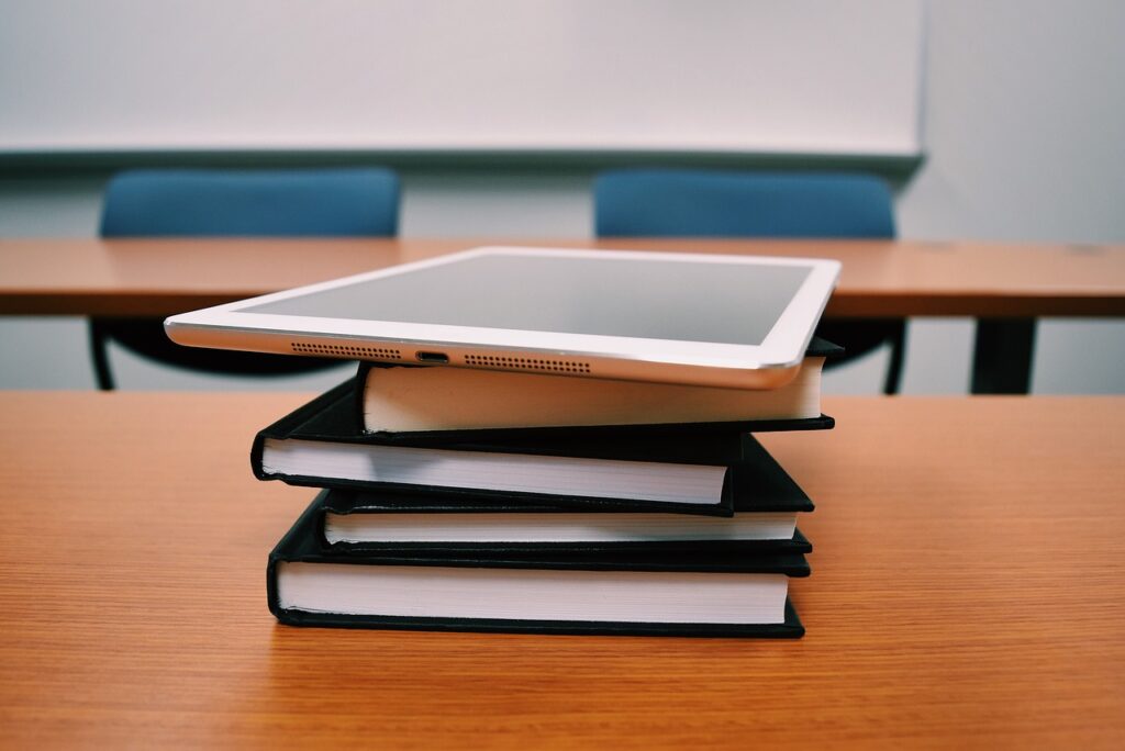 image of a tablet on top of books